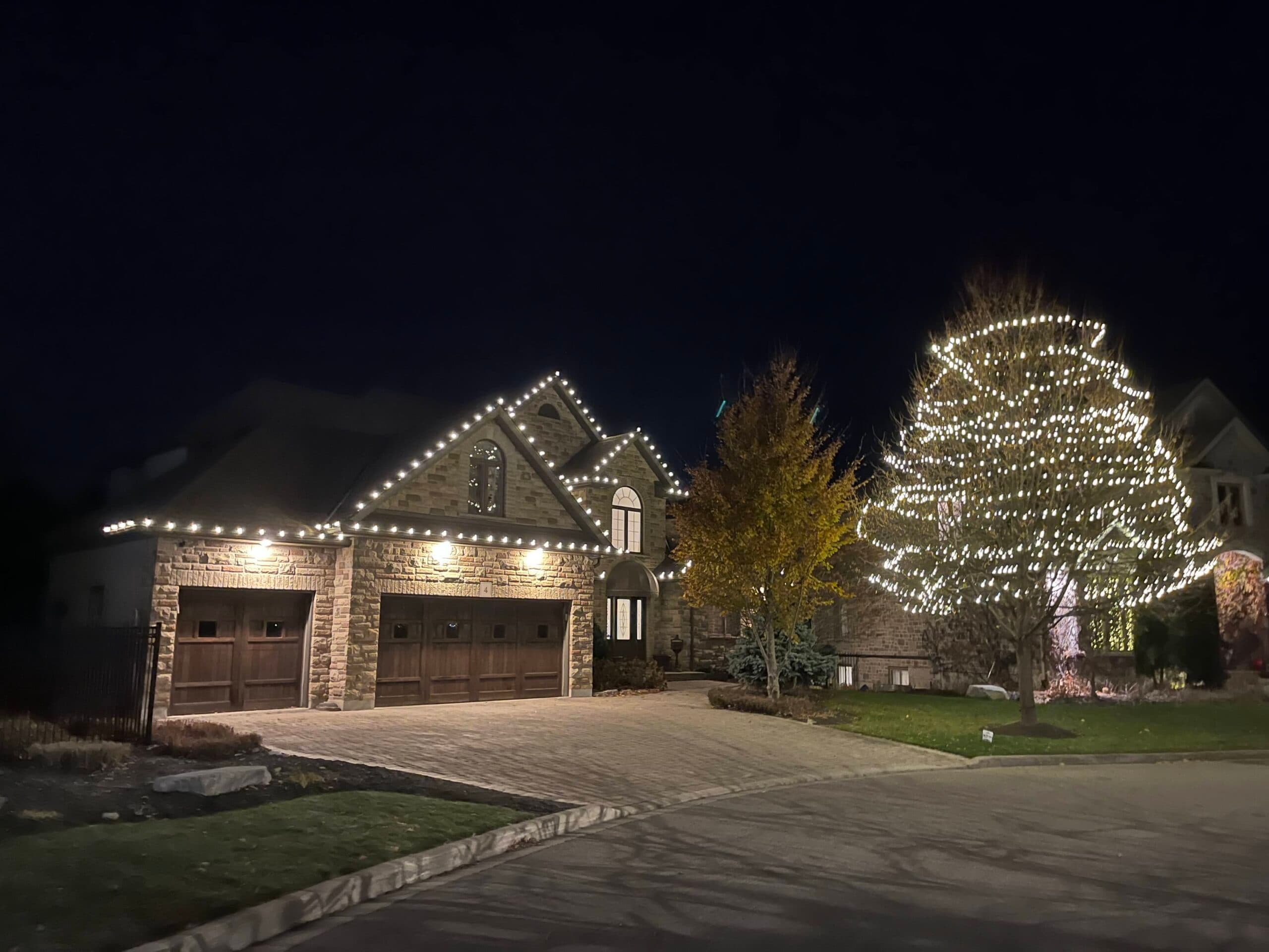Christmas Lights London team installing professional holiday lights on a home