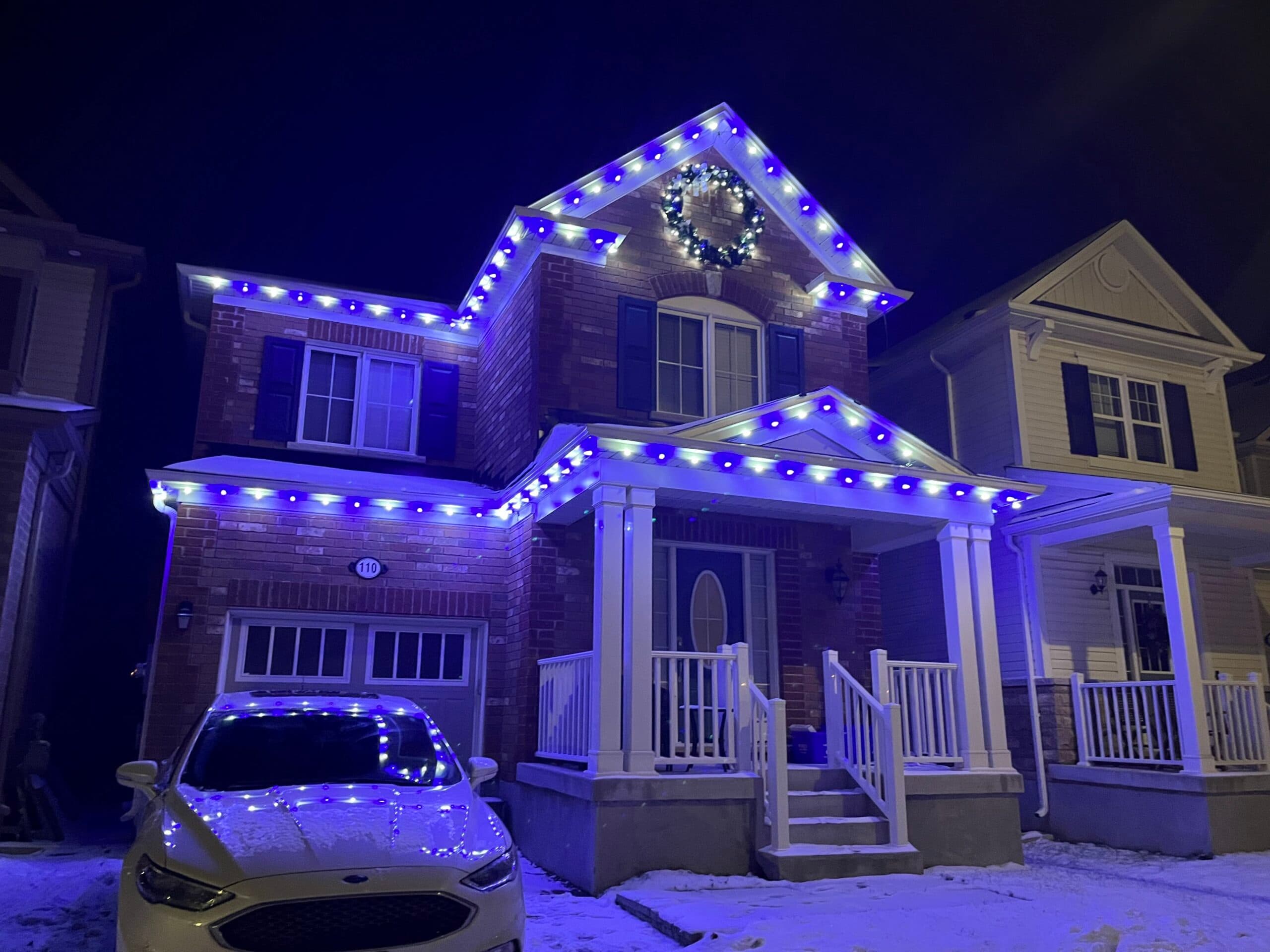 Christmas Lights London team member installing lights with aerial lift equipment